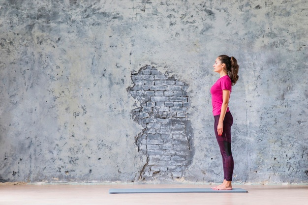 side view young woman standing exercise mat against grey weathered wall 23 2147941396
