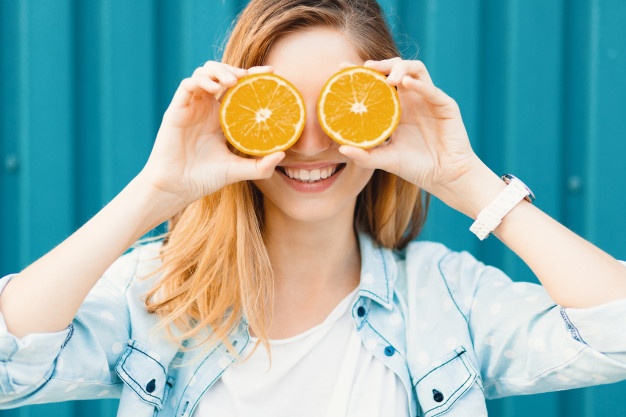 carefree young beautiful girl using two halfs oranges instead glasses her eyes 158595 1358