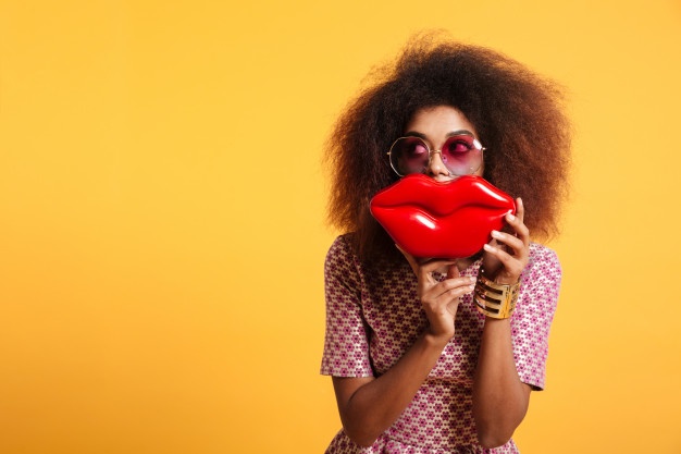 close up portrait funny afro american wooman sunglasses holding big red lips front her face looking aside 171337 8685