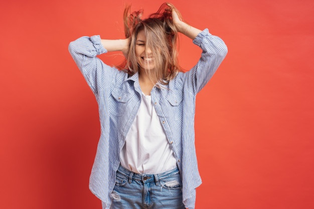 funny cute girl having fun while playing with hair isolated red wall 158595 4946