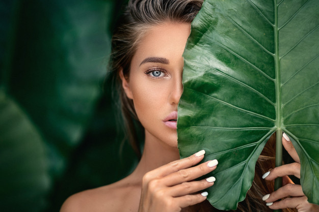 luxury portrait beautiful young woman with natural makeup holds big green leaf blurred green 120960 41