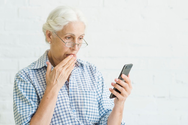 shocked aged woman looking mobile against backdrop 23 2147918183
