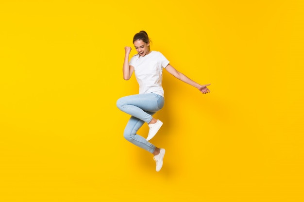 young woman jumping isolated yellow wall 1368 43192