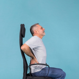 senior man sitting chair having back pain blue background 23 2148032394 1
