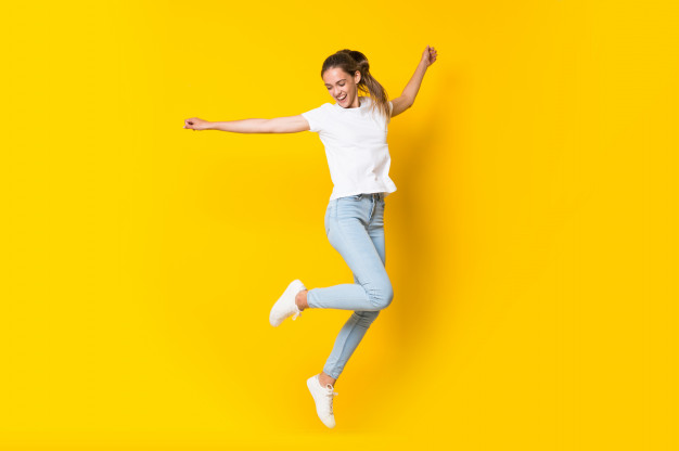 young woman jumping isolated yellow wall 1368 45425
