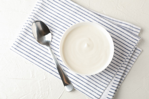 bowl sour cream yogurt spoon towel white cement background 185193 6781