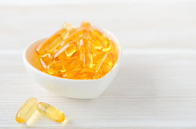 fish oil capsules white wooden background 73387 896