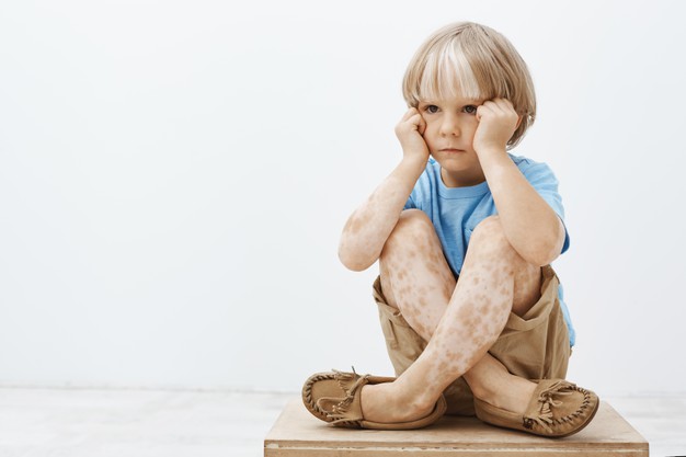 little boy feeling gloomy being like every other child unhappy cute blond child sitting with crossed feet floor holding hands face looking aside 176420 24856