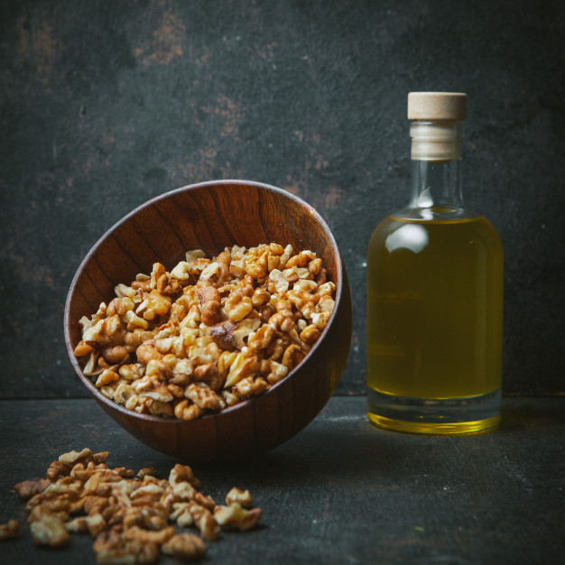 peeled walnuts brown bowl with walnut oil glass bottle side view dark table 176474 5497