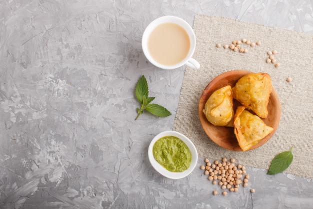 traditional indian food samosa wooden plate with mint chutney gray concrete copyspace top view 71985 2679