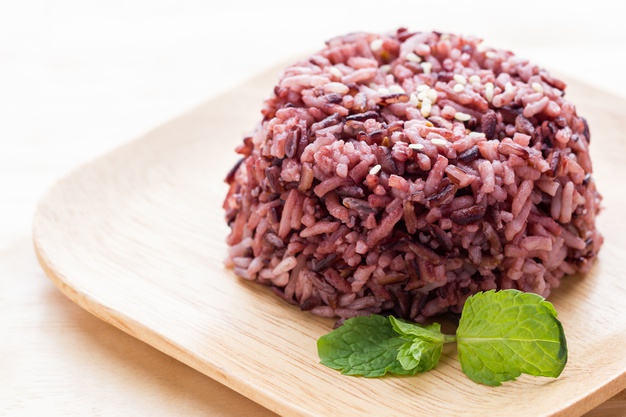 cooked purple rice berry wooden plate with peppermint leaves 52476 354