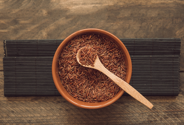 red jasmine rice grains bowl against wooden backdrop 23 2147883533