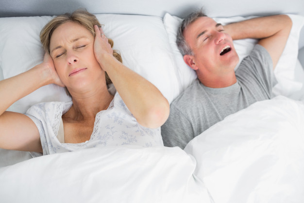 wife blocking her ears from noise husband snoring 13339 75071