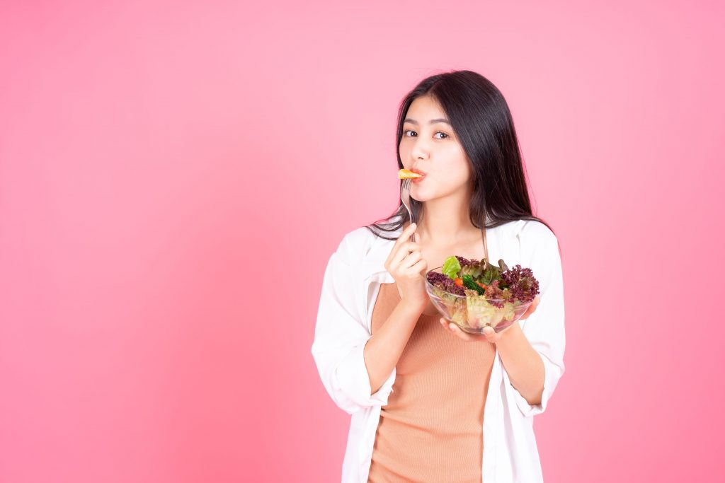beauty woman asian cute girl feel happy eating diet food fresh salad good health pink background 1
