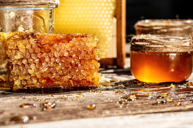 sweet honey comb glass jar with honey wooden background 114941 304