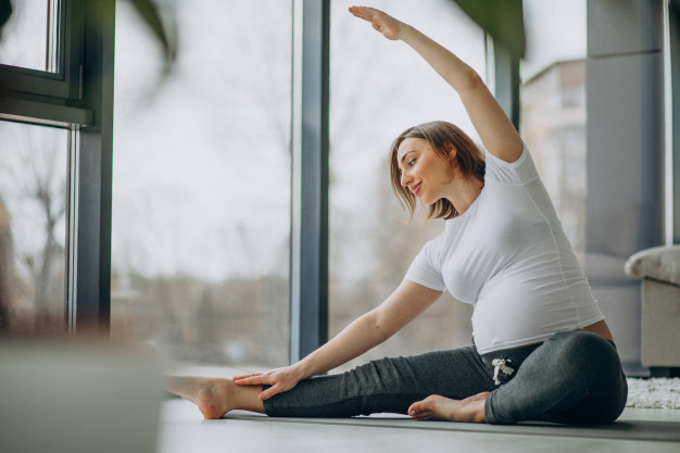 young pregnant woman practicing yoga home 1303 21112